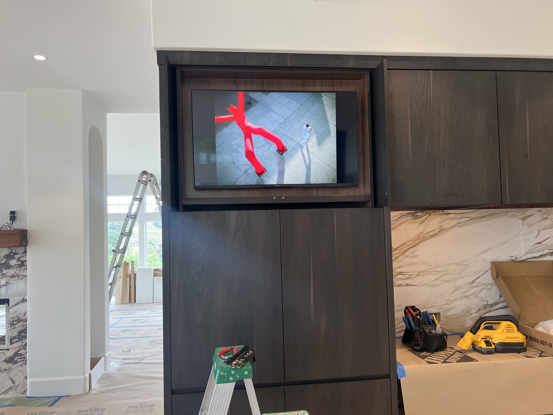 Television incorporated into kitchen cabinetry during installation